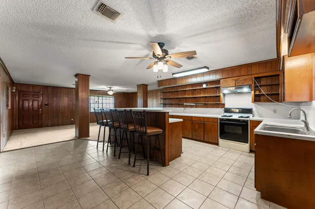 a kitchen with a stove cabinets and counter space