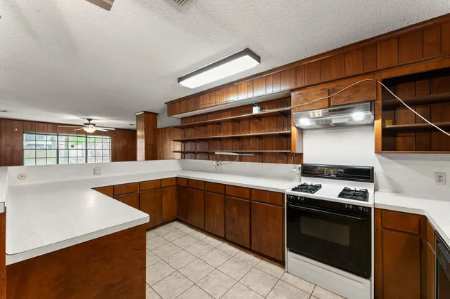 a kitchen with stainless steel appliances granite countertop a stove and a sink