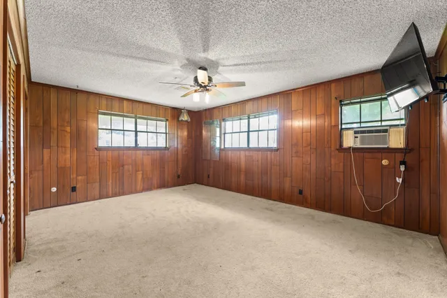 an empty room with windows and closet