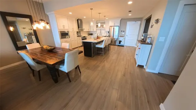 a view of a dining room with furniture and wooden floor