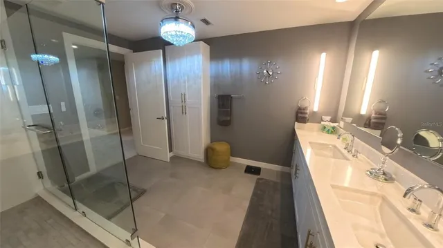 a bathroom with double vanity and a shower