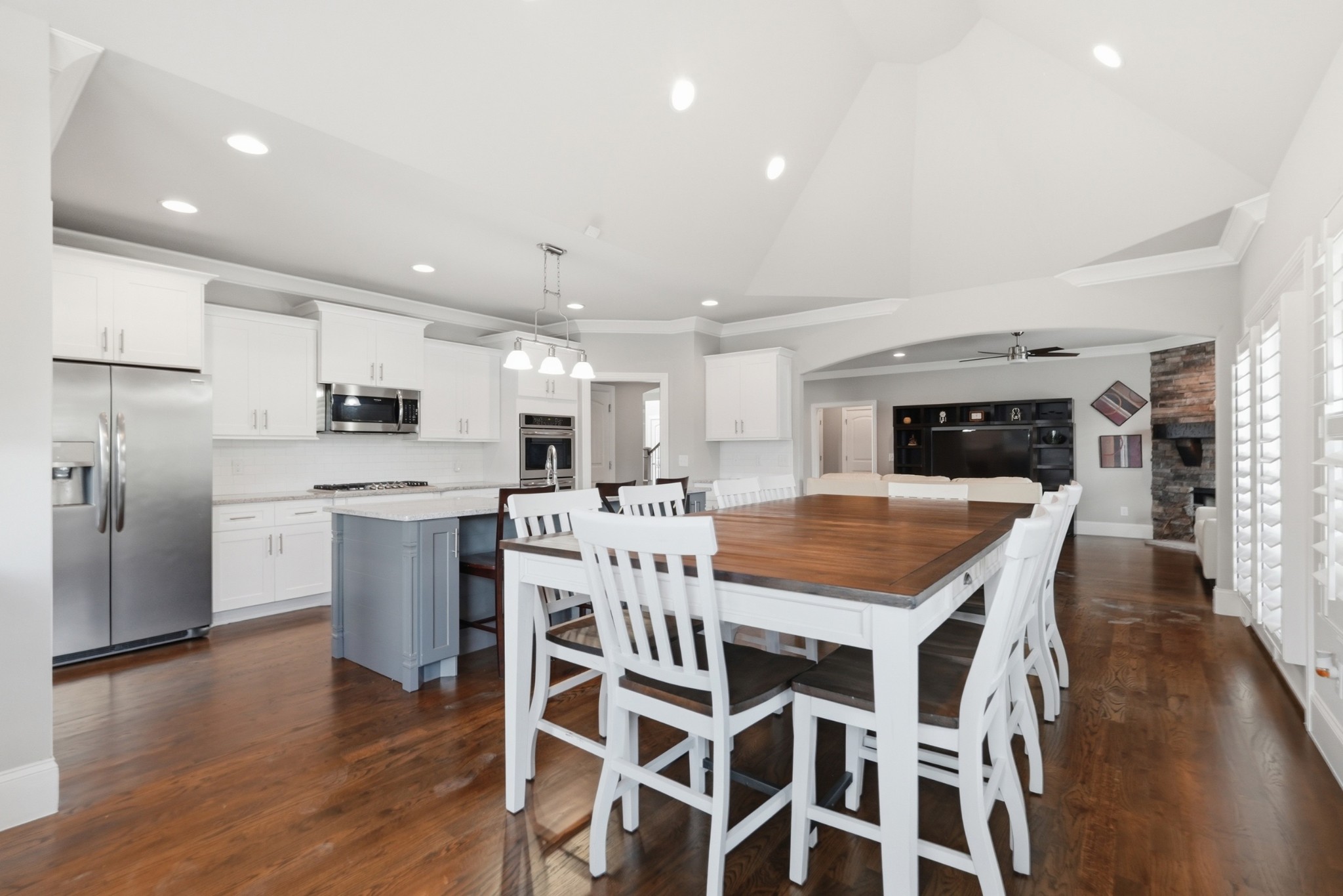 6000 Wallaby Court Spring Hill, TN 37174 - Photo 18 of 57 a kitchen with stainless steel appliances kitchen island granite countertop a table chairs sink and cabinets