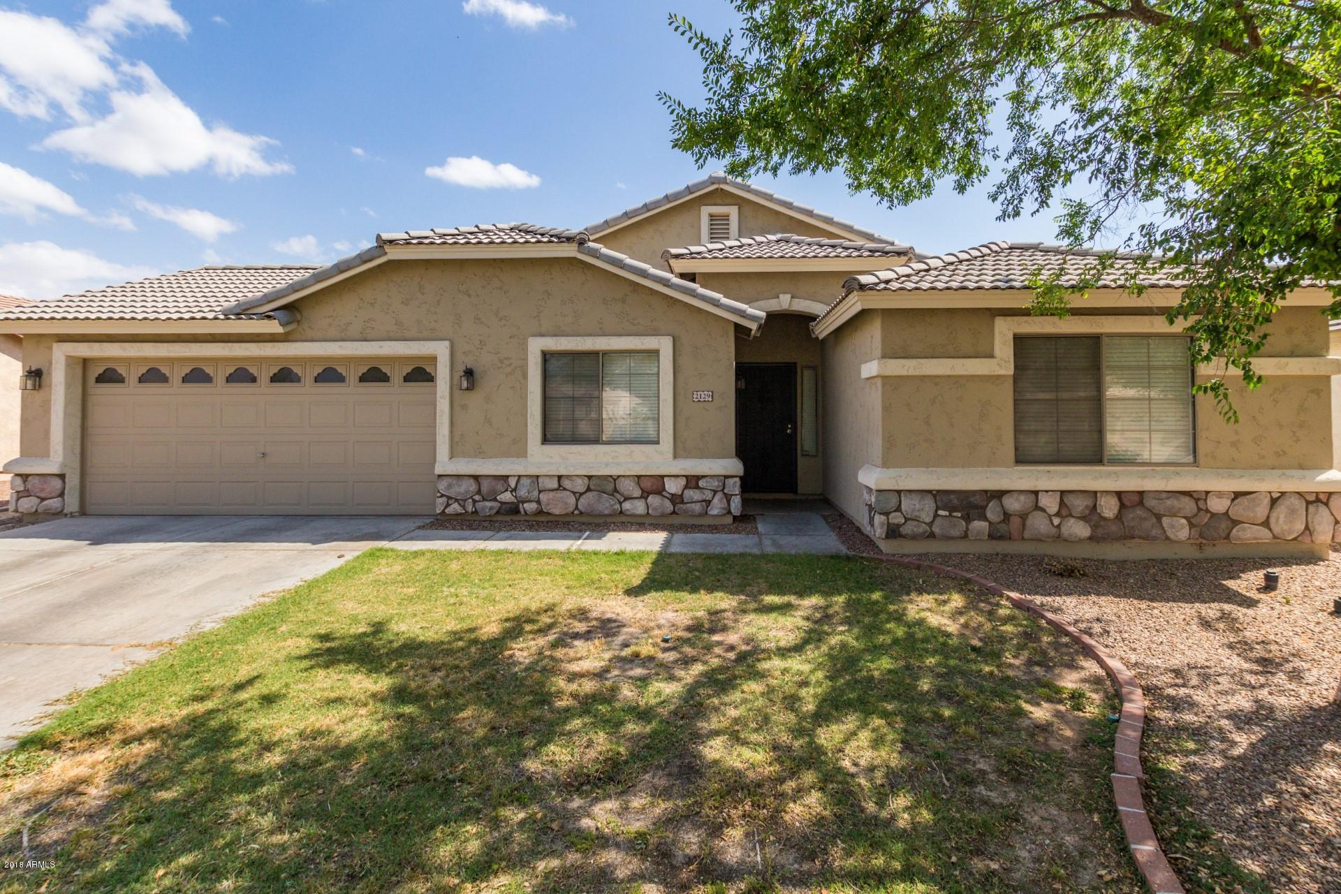 2129 West Carson Road Phoenix, AZ 85041 - Photo 1 of 22 a front view of a house with a yard