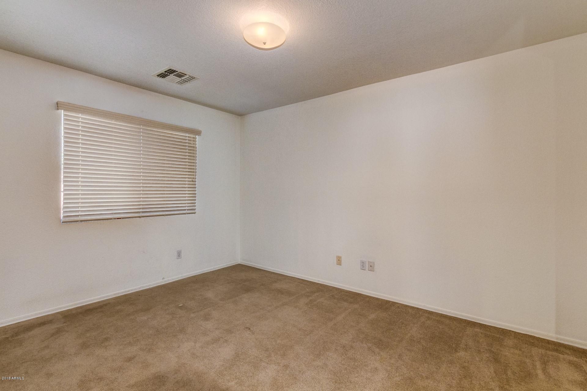 2129 West Carson Road Phoenix, AZ 85041 - Photo 13 of 22 an empty room with windows