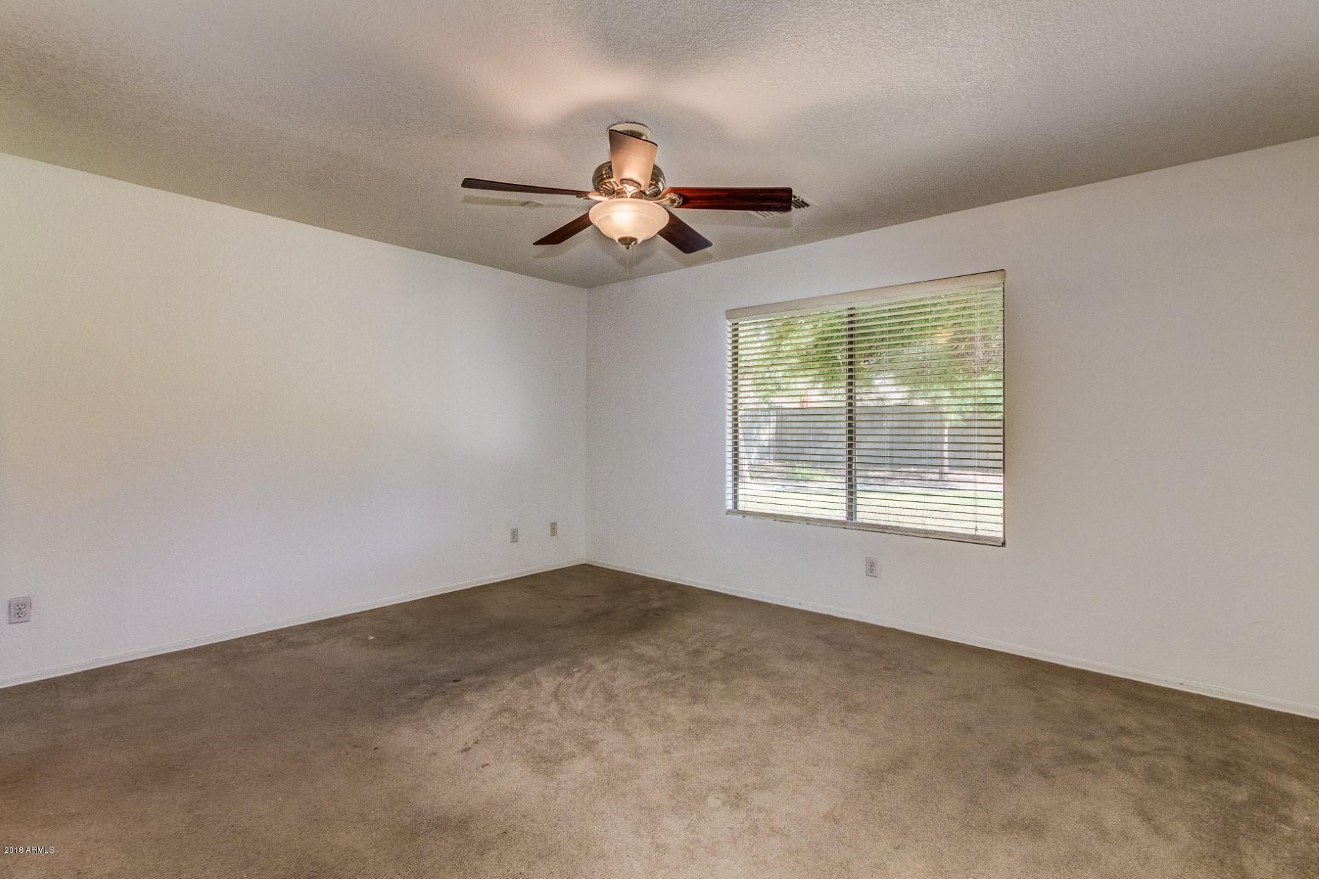 2129 West Carson Road Phoenix, AZ 85041 - Photo 15 of 22 an empty room with a window
