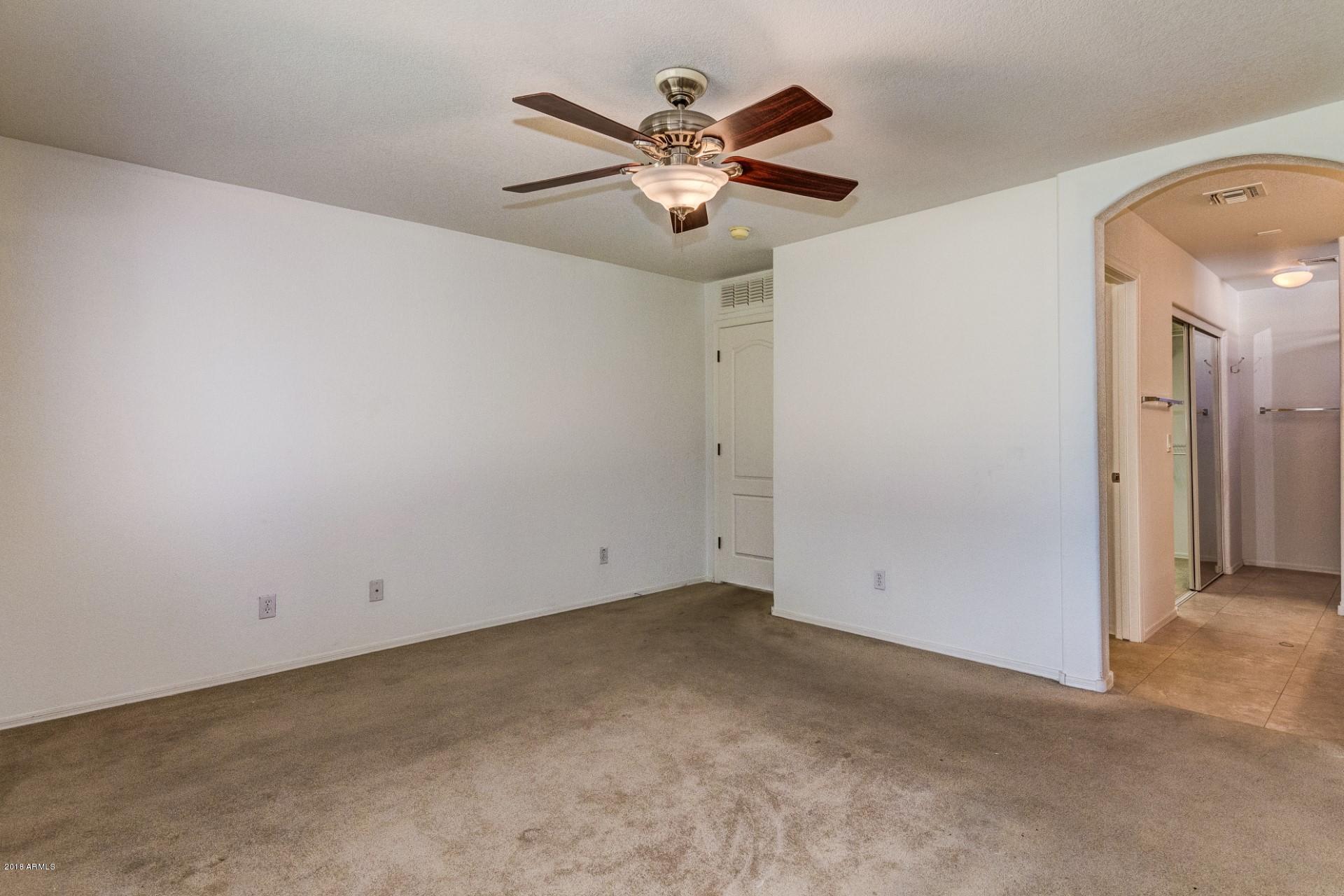 2129 West Carson Road Phoenix, AZ 85041 - Photo 16 of 22 an empty room with closet and ceiling fan