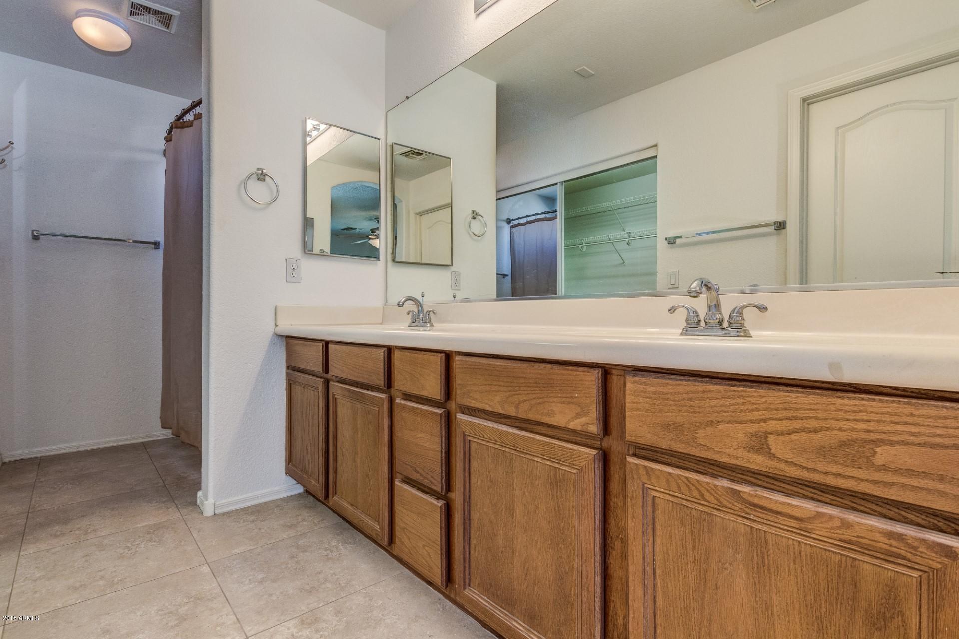 2129 West Carson Road Phoenix, AZ 85041 - Photo 17 of 22 a bathroom with a sink and a mirror