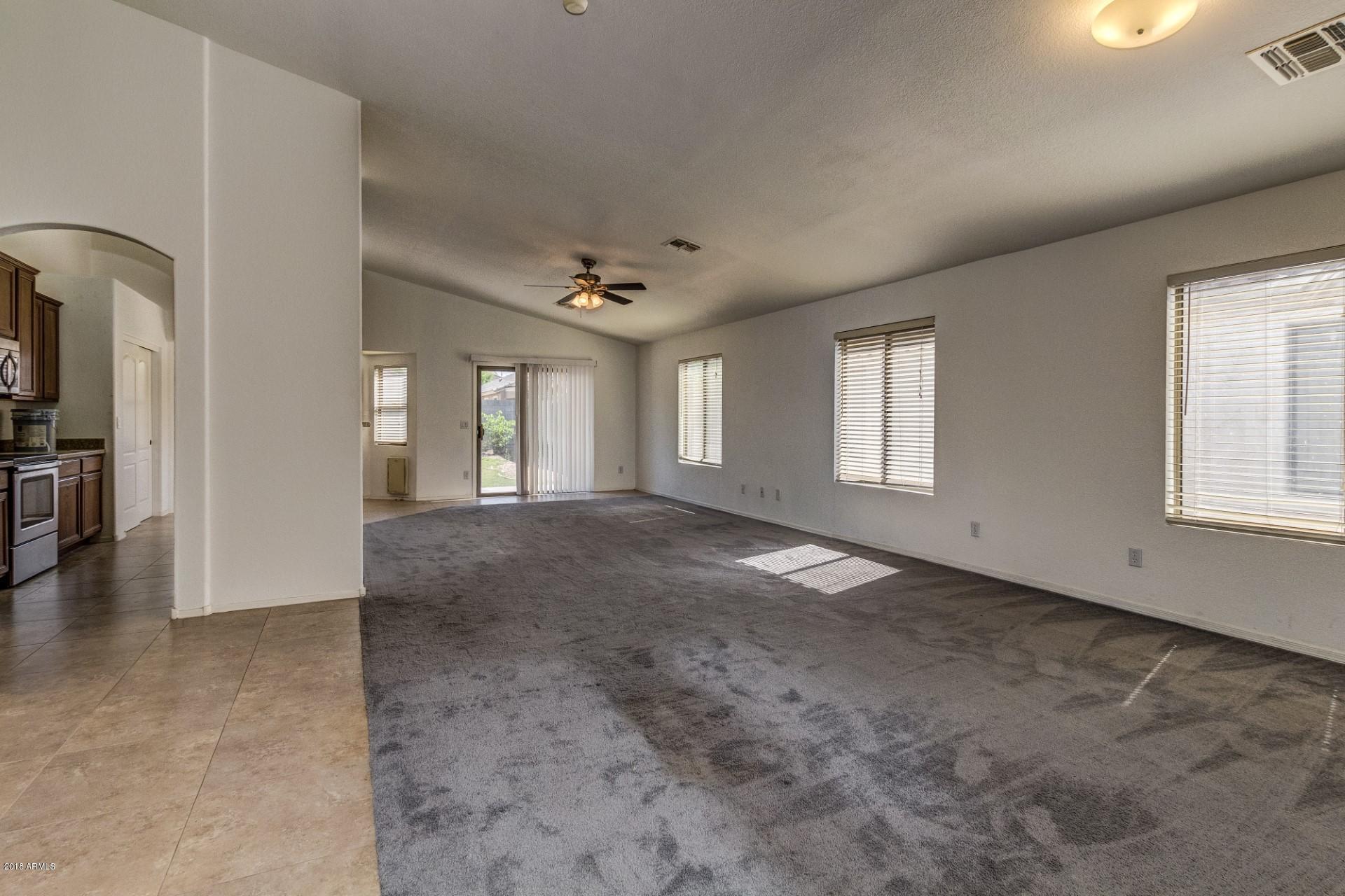 2129 West Carson Road Phoenix, AZ 85041 - Photo 7 of 22 an empty room with windows and pillars in it