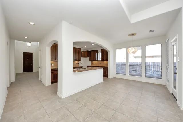 a view of a big room with windows and entryway