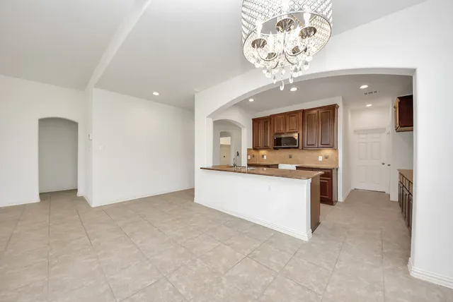 a view of kitchen with granite countertop cabinets stainless steel appliances a sink and a window
