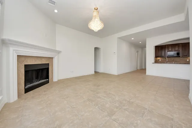 a view of empty room with a fireplace