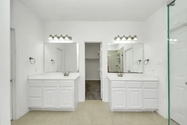 a spacious bathroom with a double vanity sink mirror and