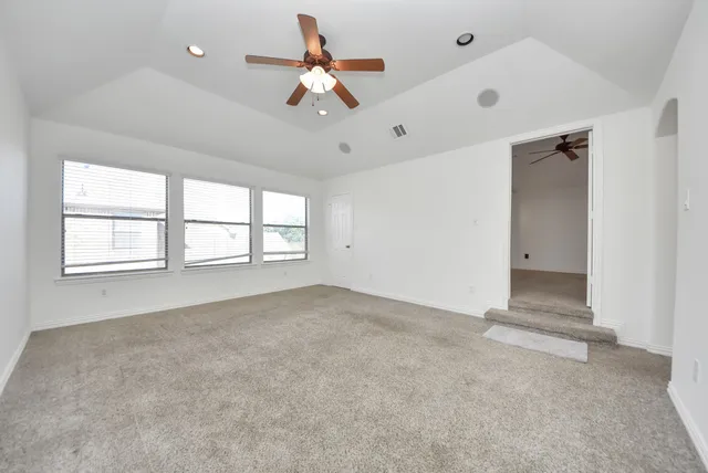 a view of an empty room with a window