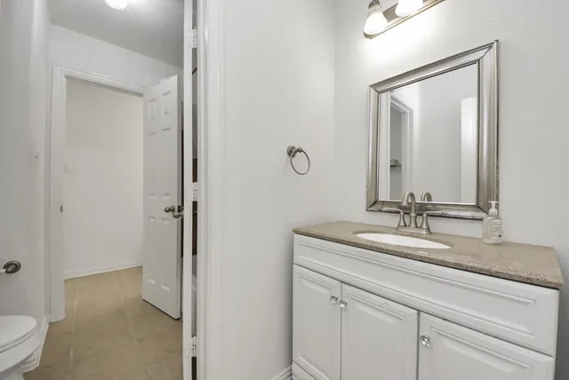 a bathroom with a sink vanity and a mirror