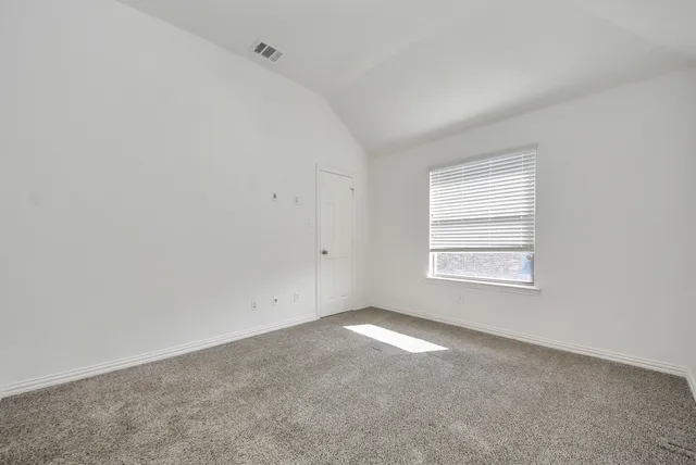 a view of an empty room with closet area