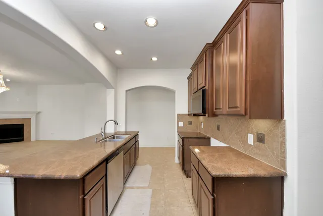 a bathroom with a granite countertop sink a mirror and vanity
