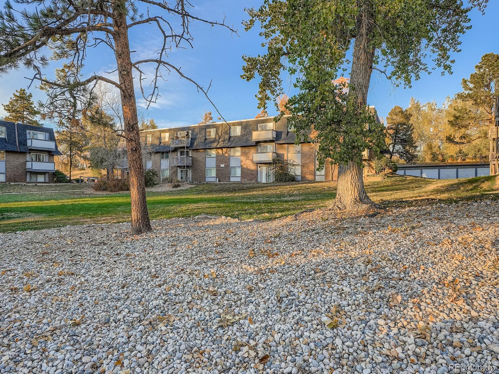 140 East Highline Circle, Unit 105 Centennial, CO 80122 - Photo 20 of 29 a view of a house with a yard and a large tree