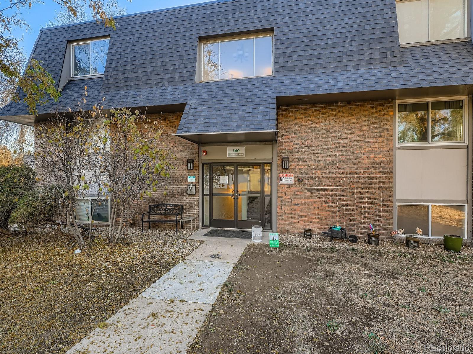 140 East Highline Circle, Unit 105 Centennial, CO 80122 - Photo 2 of 29 a front view of a house with garden