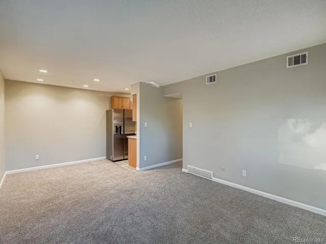 a kitchen with stainless steel appliances granite countertop a refrigerator a sink and a stove