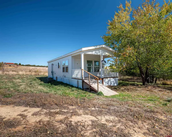 a view of a house with backyard porch and sitting area