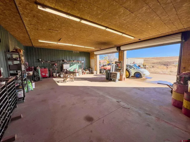 a view of a patio with table and chairs a barbeque