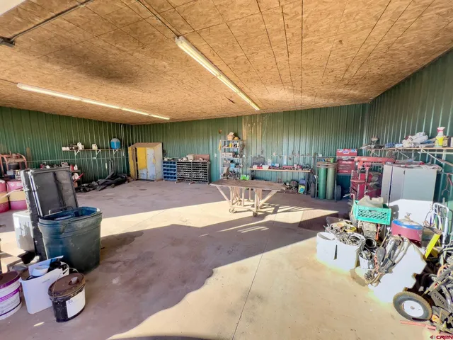 a view of a dry yard with wooden fence