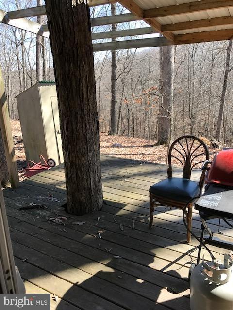 507 Easter Ridge Lane Winchester, VA 22603 - Photo 12 of 30 a roof deck with table and chairs and wooden floor
