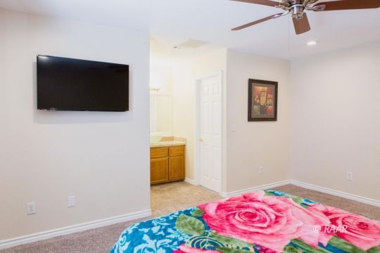 642 Regency Court Ridgecrest, CA 93555 - Photo 19 of 33 a bedroom with a bed and a flat screen tv