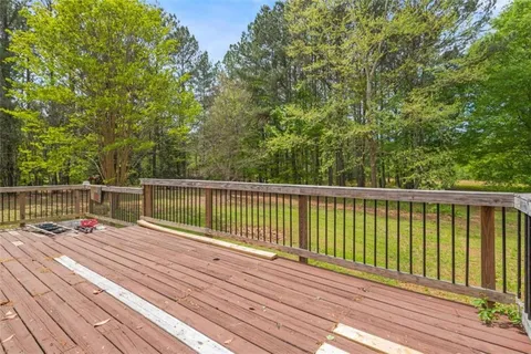 a view of balcony with wooden floor and fence