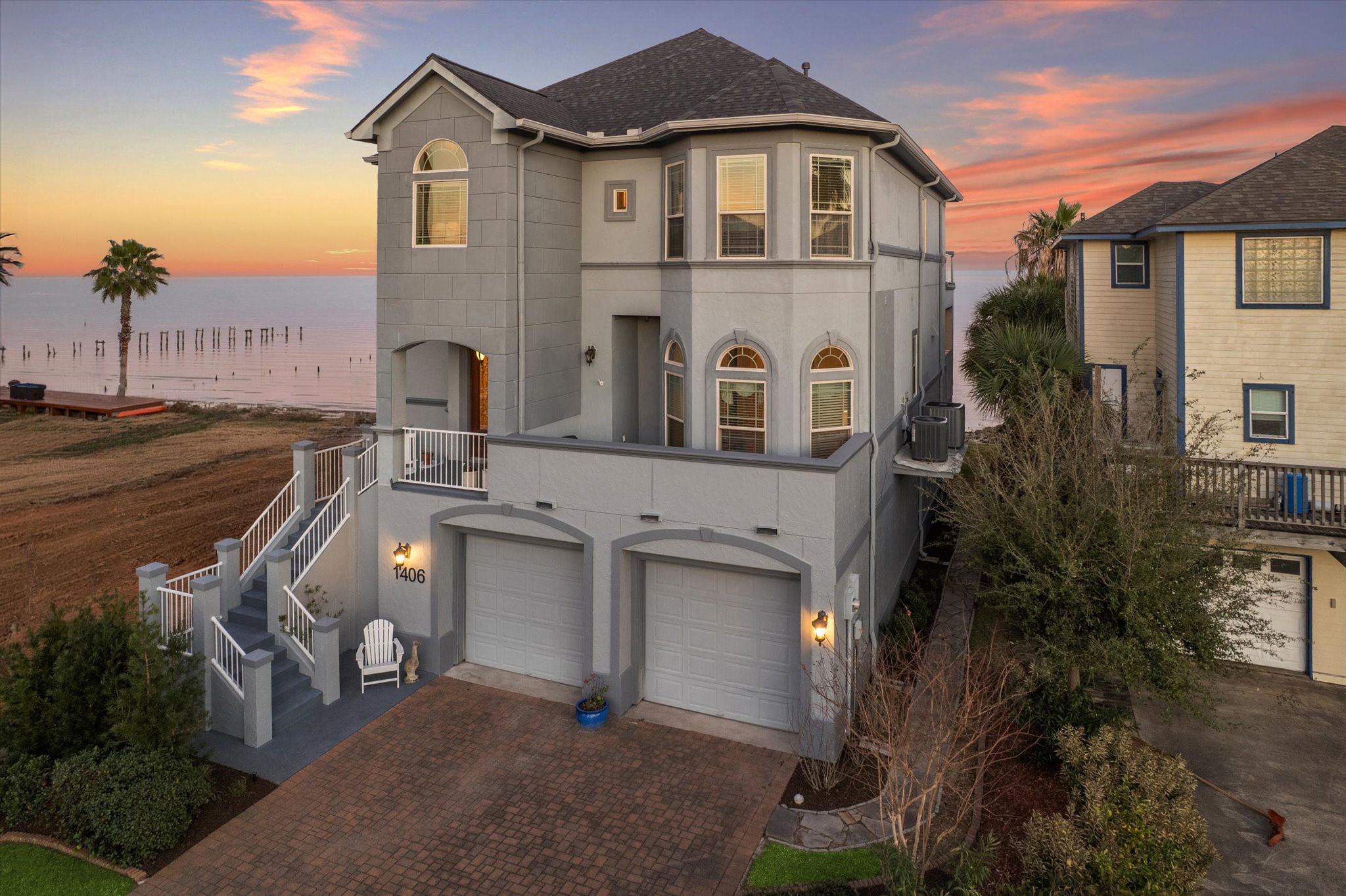 1406 Todville Road Seabrook, TX 77586 - Photo 5 of 50 THE FRONT ELEVATION REVEALS A PAVERED DRIVEWAY, PRIVATE FRONT BALCONY AND A FRONT PORCH.