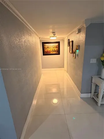 a view of a hallway with paintings on the wall