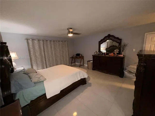 a bed room with a bed and a chair