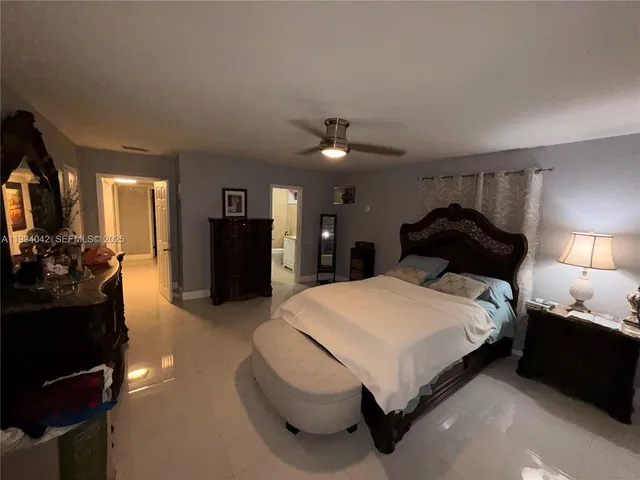 a bedroom with a bed and a large mirror