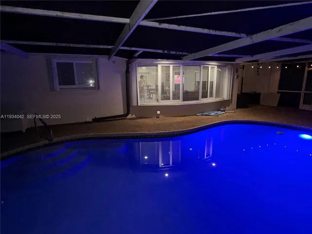 a view of swimming pool with outdoor seating