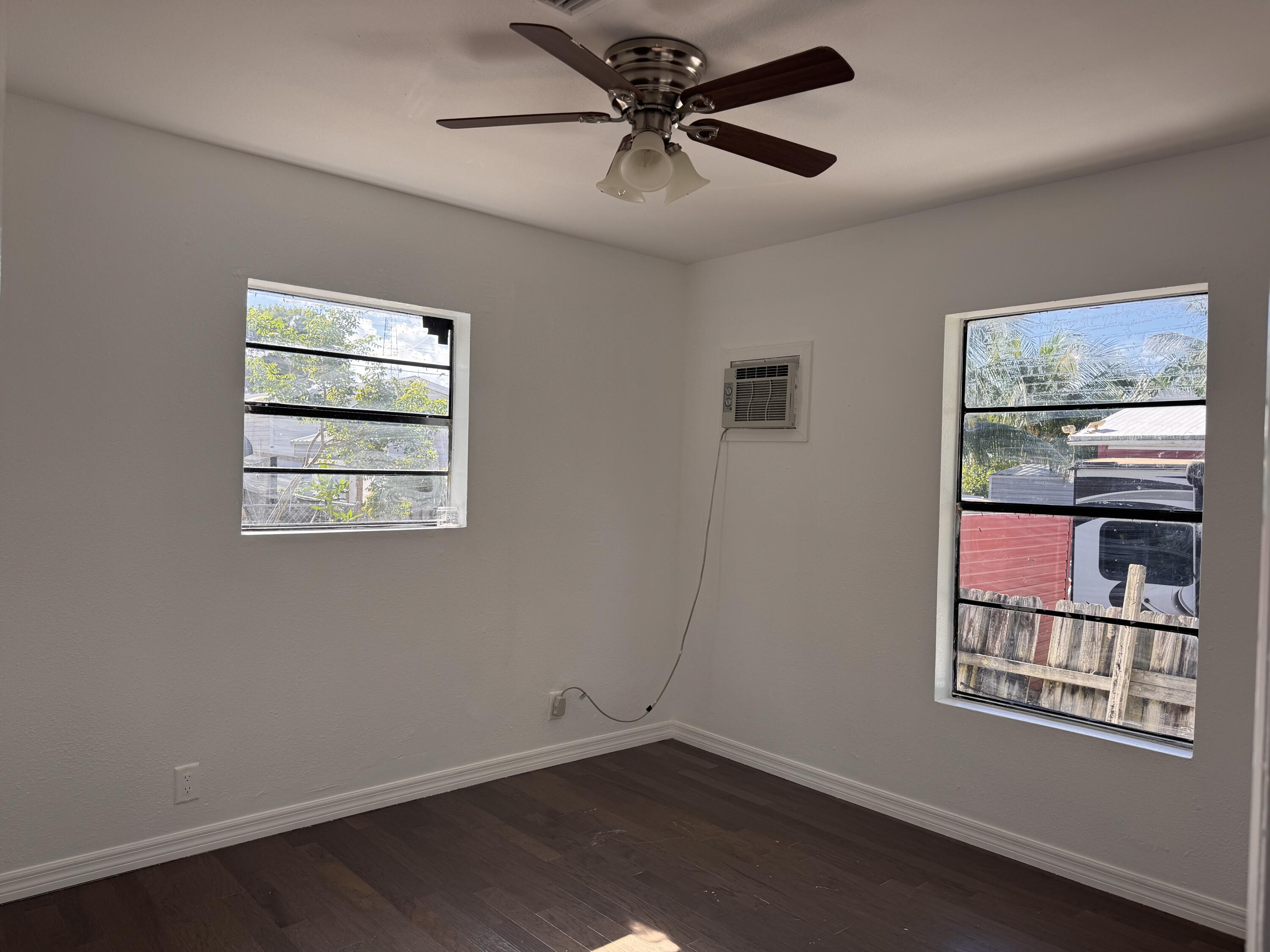 969 Plantation Road Key Largo, FL 33037 - Photo 13 of 26 a view of an empty room with window and wooden floor