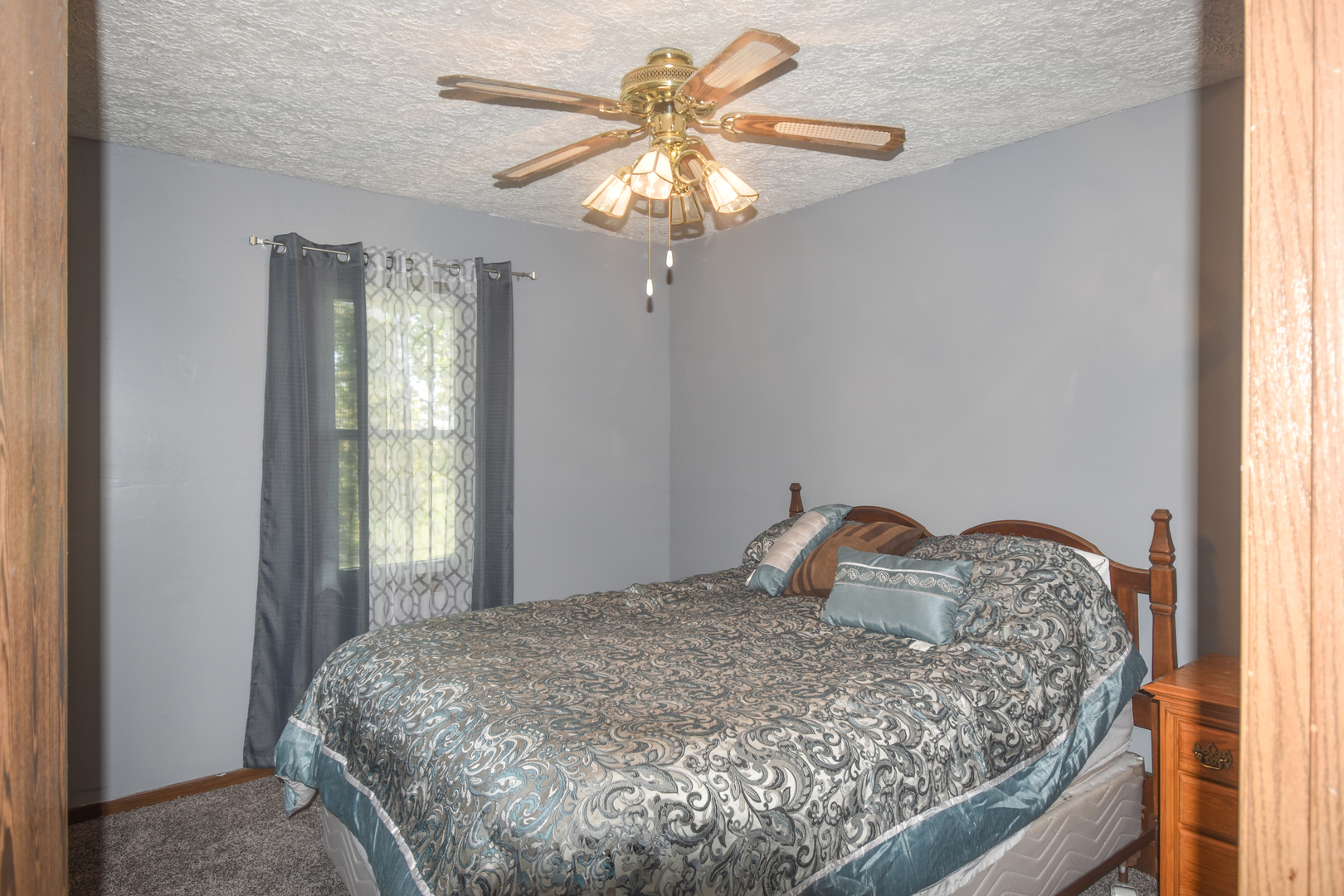 506 Boxelder Street Odell, IL 60460 - Photo 14 of 15 a bedroom with a bed and a chandelier
