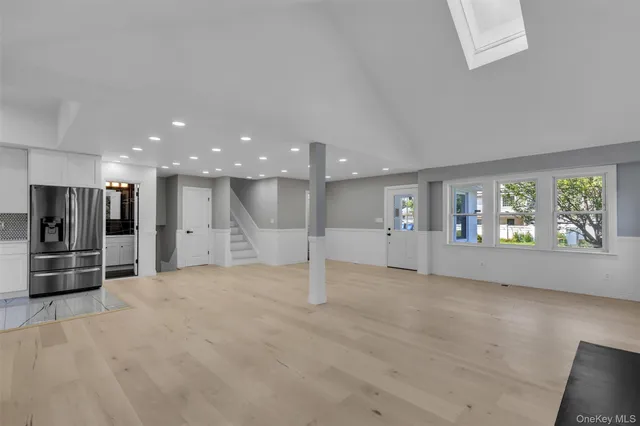 a view of kitchen with refrigerator and window