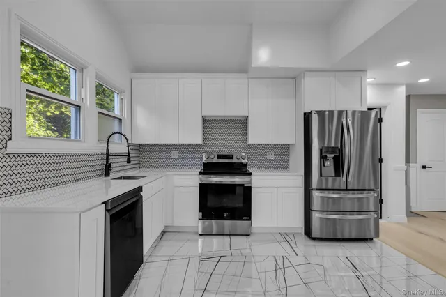 a kitchen with a stove a refrigerator and a sink