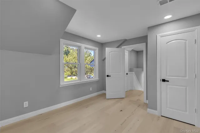 a view of entryway with window and hardwood floor