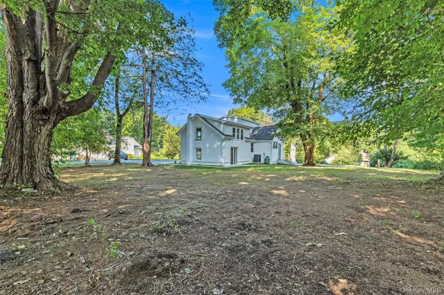 a view of a house with yard and tree s