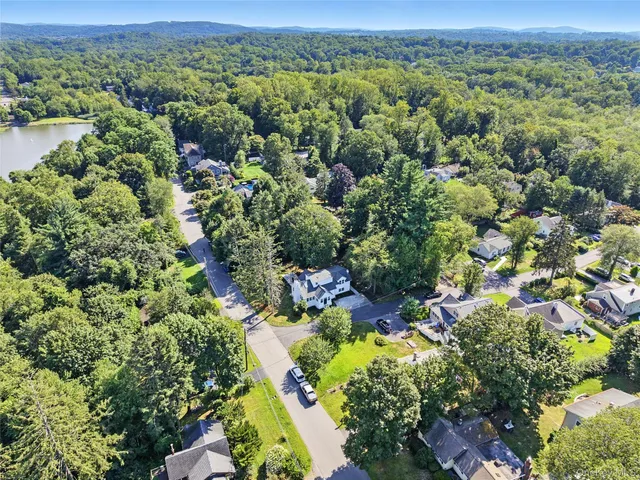 an aerial view of a houses with a yard