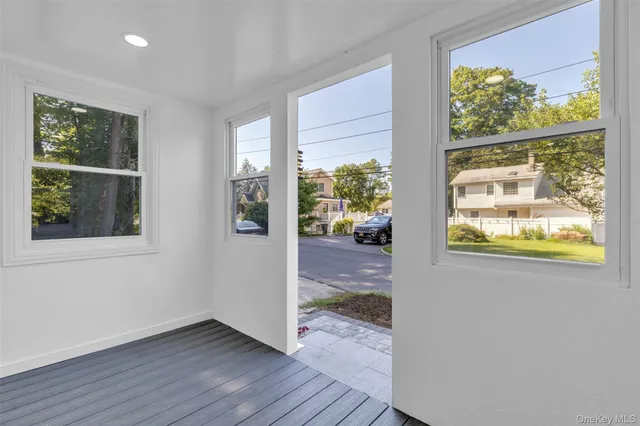 a view of an entryway with wooden floor and a window