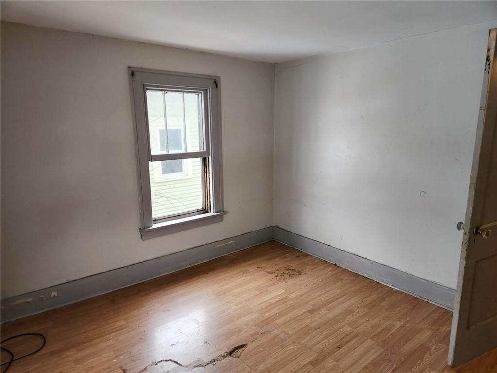 399 Baldwin Avenue Sharon, PA 16146 - Photo 13 of 23 an empty room with wooden floor and windows