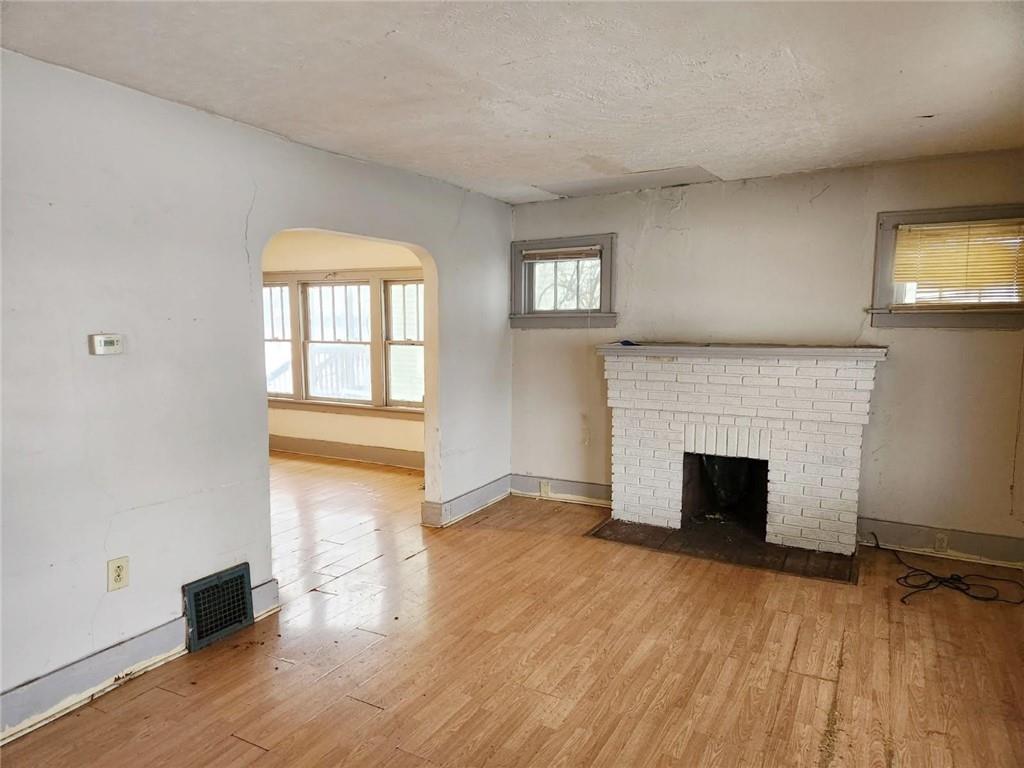 399 Baldwin Avenue Sharon, PA 16146 - Photo 3 of 23 wooden floor fireplace and windows in an empty room