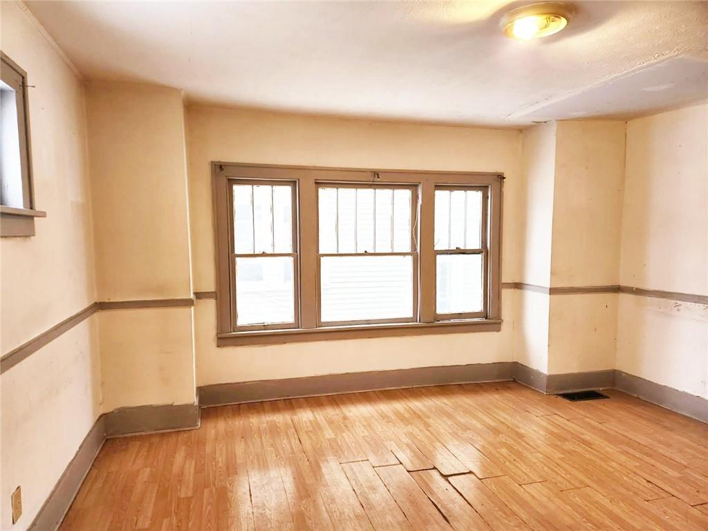 399 Baldwin Avenue Sharon, PA 16146 - Photo 8 of 23 a view of an empty room with a window and wooden floor