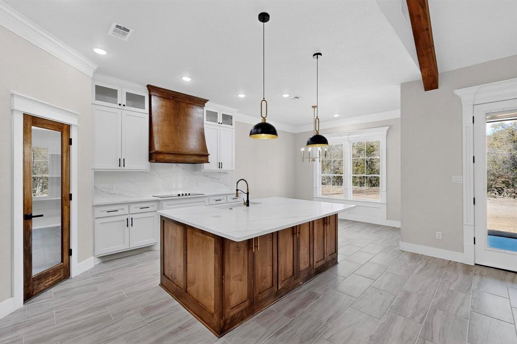 1161 Gonzollas Road Springtown, TX 76082 - Photo 11 of 40 a kitchen with a sink stove and cabinets