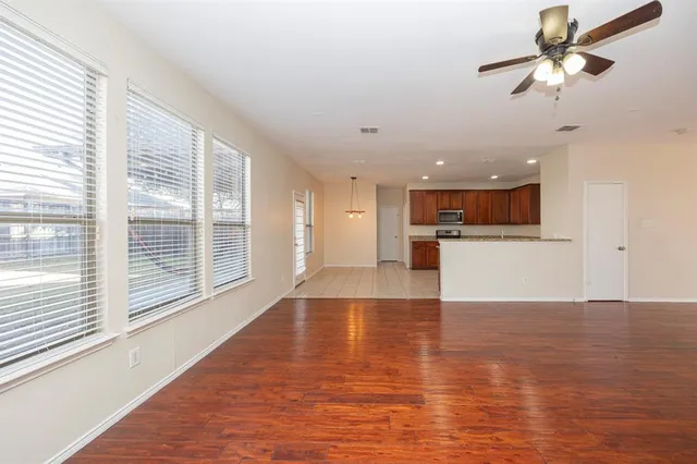 a view of kitchen with cabinets and wooden floor