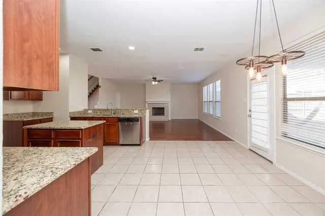 a kitchen with stainless steel appliances granite countertop a sink and a stove