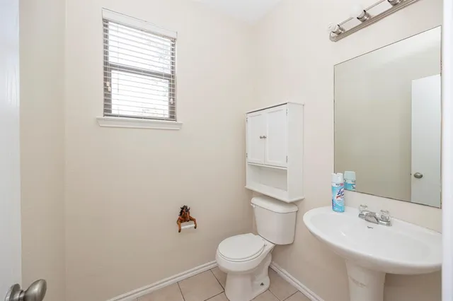 a bathroom with a sink toilet and a mirror