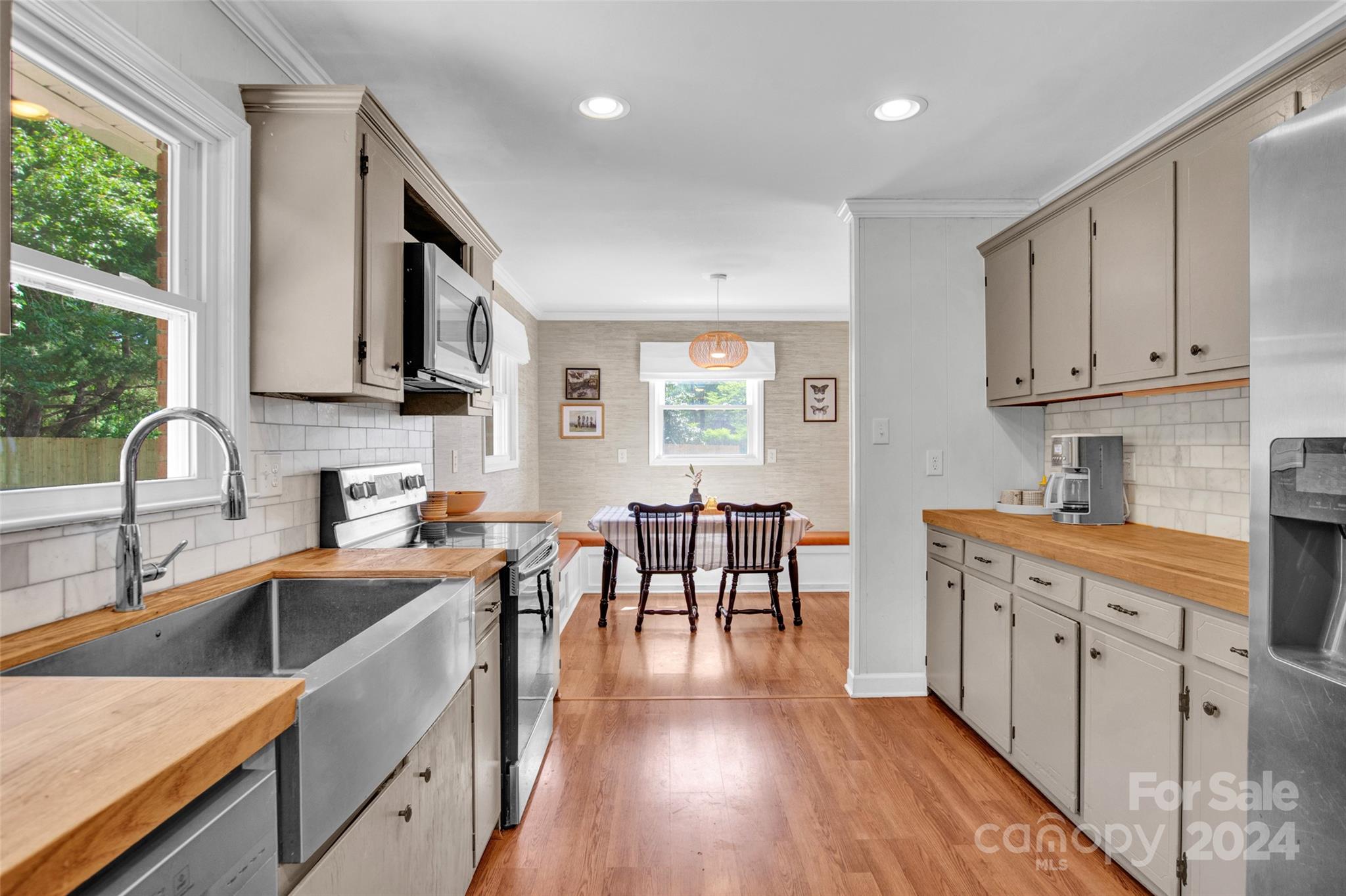326 Gilbert Road Statesville, NC 28677 - Photo 11 of 25 a kitchen with stainless steel appliances granite countertop a stove a sink a dining table and chairs